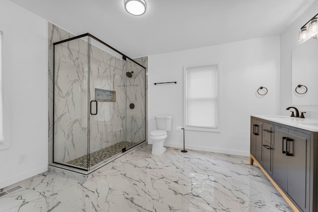 full bath featuring toilet, marble finish floor, a marble finish shower, and vanity