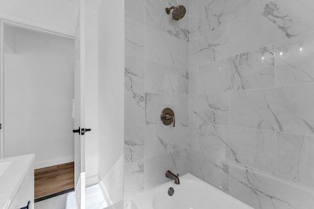 bathroom with vanity, baseboards, and shower / bathtub combination