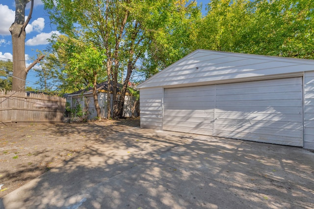 detached garage featuring fence