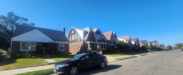 view of front facade with brick siding and a residential view