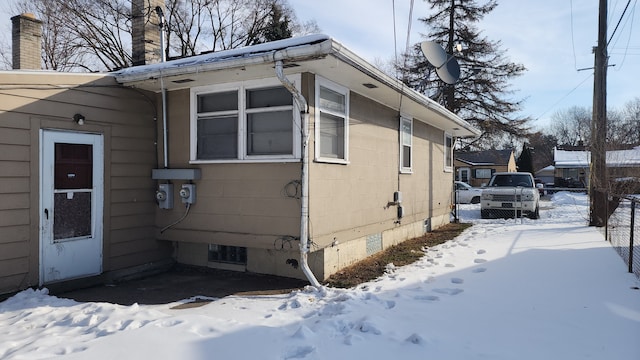 view of snowy exterior featuring crawl space