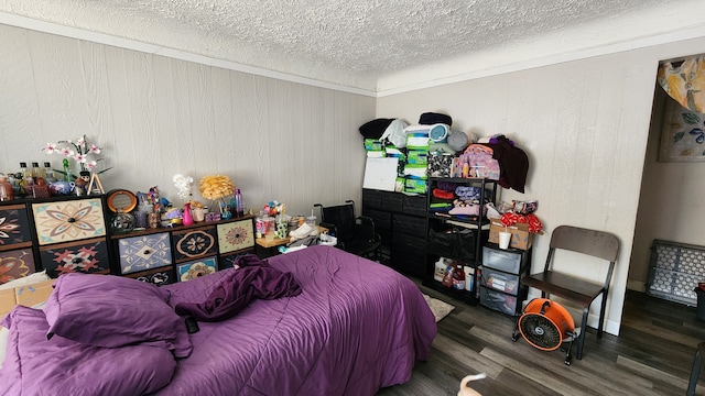 bedroom with a textured ceiling and wood finished floors