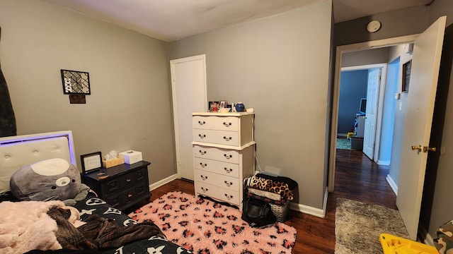 bedroom with baseboards and wood finished floors