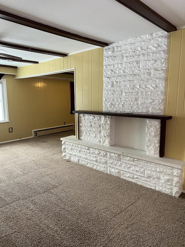 unfurnished living room with a baseboard radiator, beamed ceiling, wooden walls, and carpet