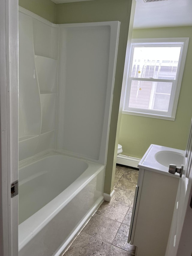 full bath with a baseboard radiator, toilet, stone tile floors, visible vents, and vanity