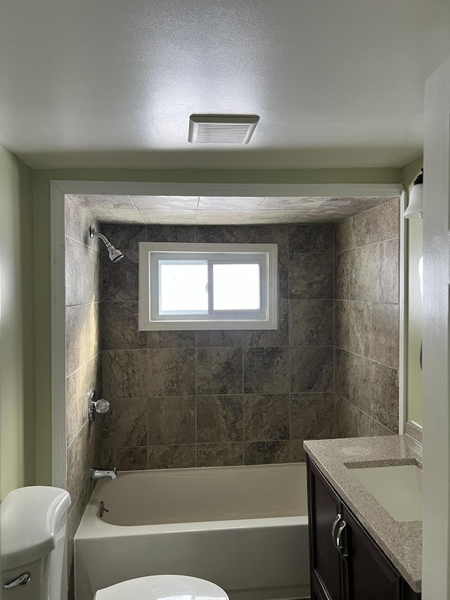 full bathroom with toilet, shower / bath combination, visible vents, and vanity