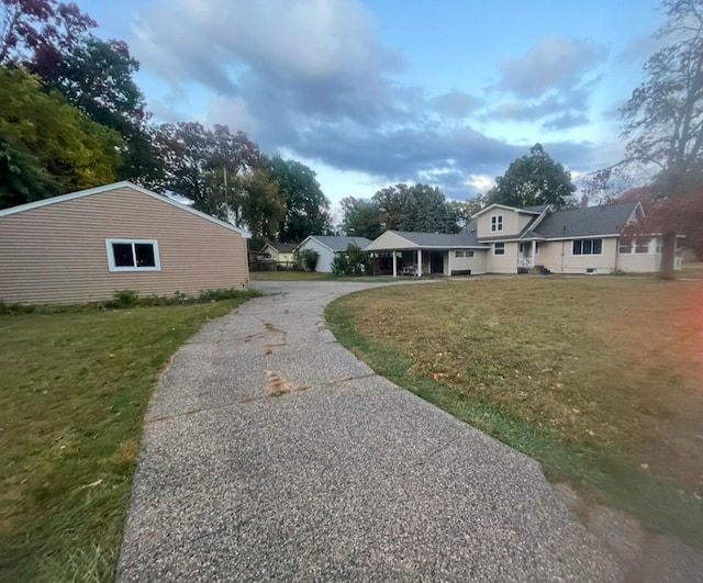 exterior space featuring driveway and a front lawn