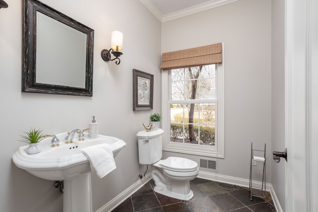 bathroom with visible vents, toilet, baseboards, and ornamental molding