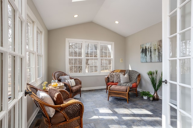 sitting room with baseboards, recessed lighting, vaulted ceiling, stone finish floor, and french doors