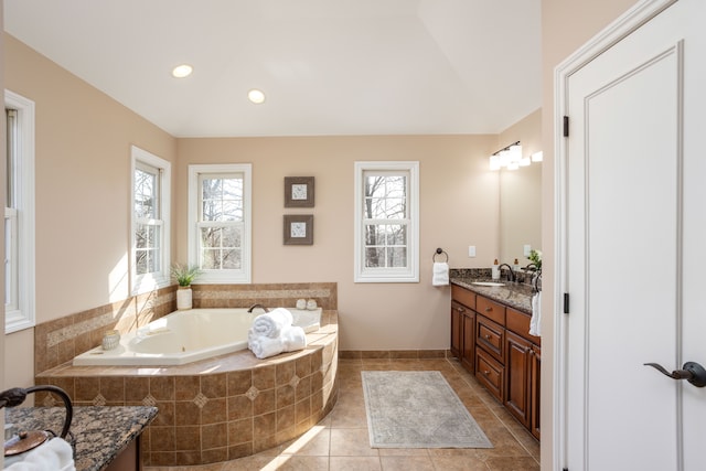 bathroom with vanity, a garden tub, recessed lighting, and tile patterned floors