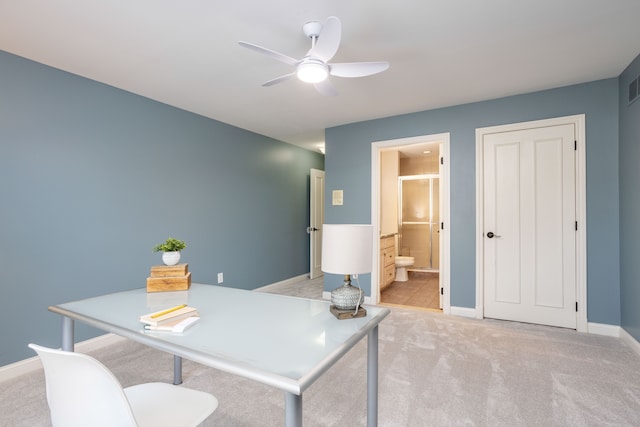 office space featuring light carpet, visible vents, ceiling fan, and baseboards