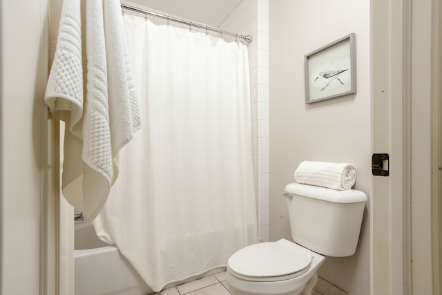 full bathroom with tile patterned flooring, shower / bath combination with curtain, and toilet