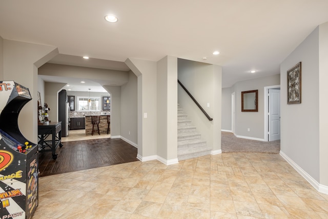 foyer featuring stairs, recessed lighting, and baseboards