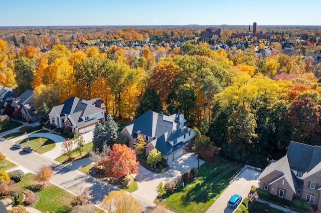 aerial view featuring a forest view and a residential view