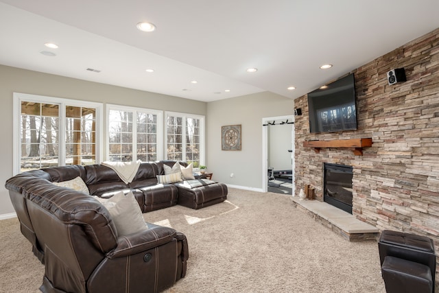 carpeted living area with a barn door, recessed lighting, a fireplace, and baseboards