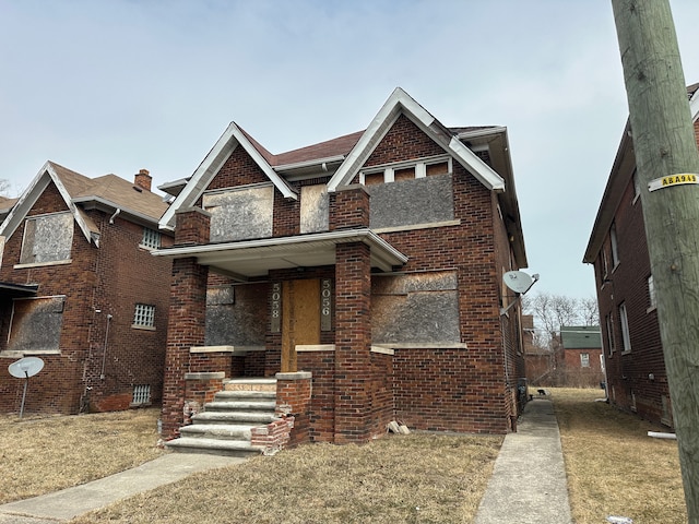 view of front of home featuring a porch and brick siding