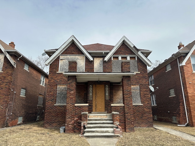 view of front facade with covered porch and brick siding