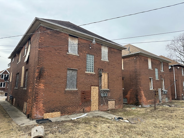 view of side of home featuring brick siding