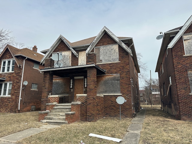 view of front of home featuring a porch and brick siding