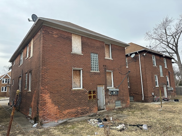 view of side of home with brick siding