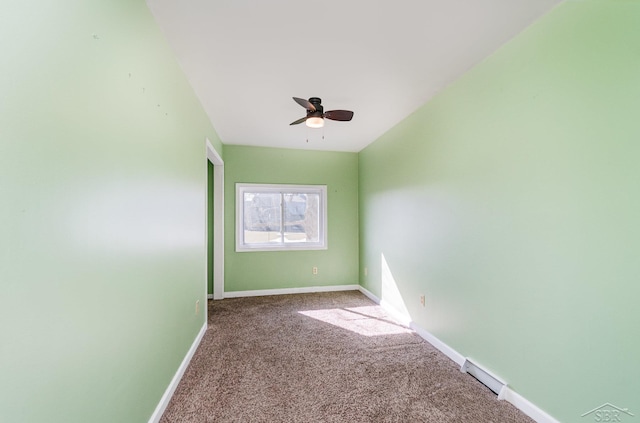 carpeted empty room featuring baseboards, visible vents, and ceiling fan