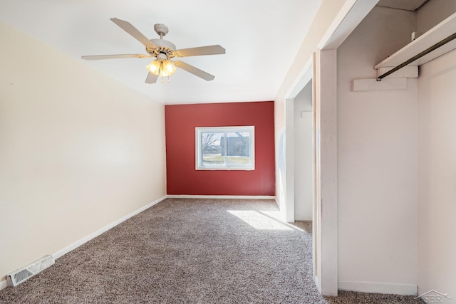 interior space featuring ceiling fan, carpet, visible vents, and baseboards