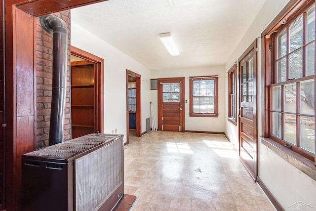 entryway with a textured ceiling and baseboards