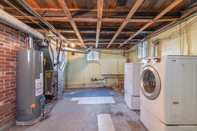 basement with water heater, washing machine and dryer, and heating unit