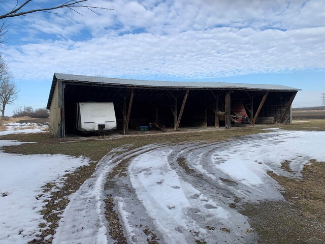 snow covered structure with an outdoor structure