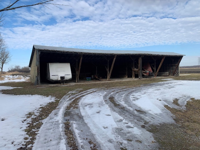 snow covered structure featuring an outdoor structure