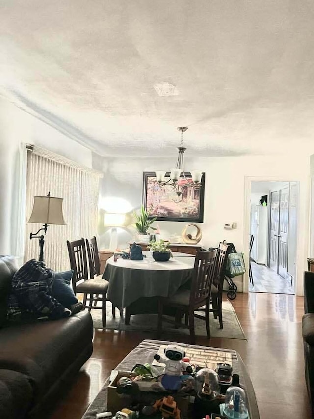 dining area featuring wood finished floors and a notable chandelier