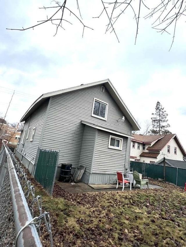 back of property with central air condition unit and fence