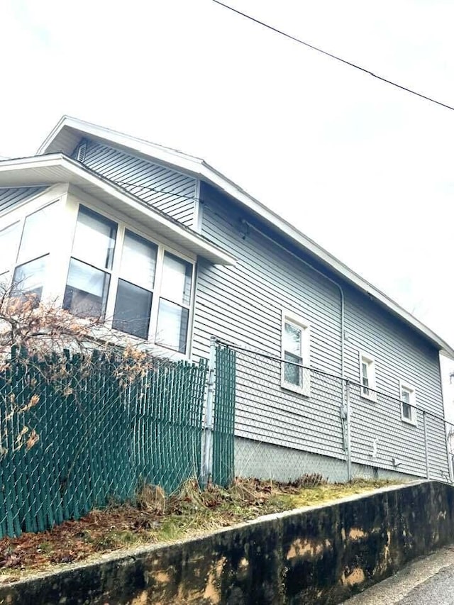 view of side of home with fence