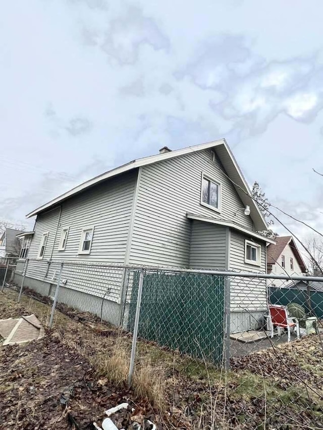 view of side of property featuring fence