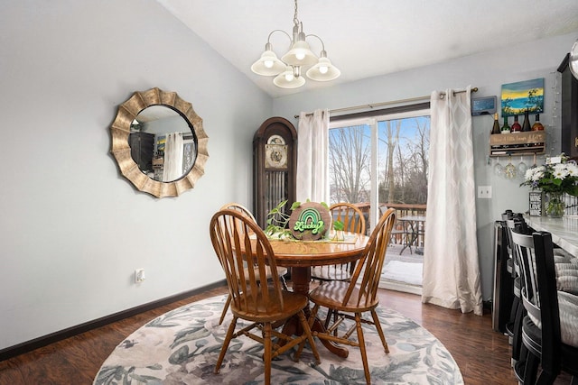 dining space with lofted ceiling, baseboards, dark wood finished floors, and a notable chandelier