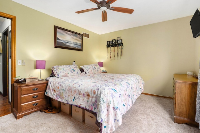 bedroom with carpet floors, baseboards, visible vents, and a ceiling fan