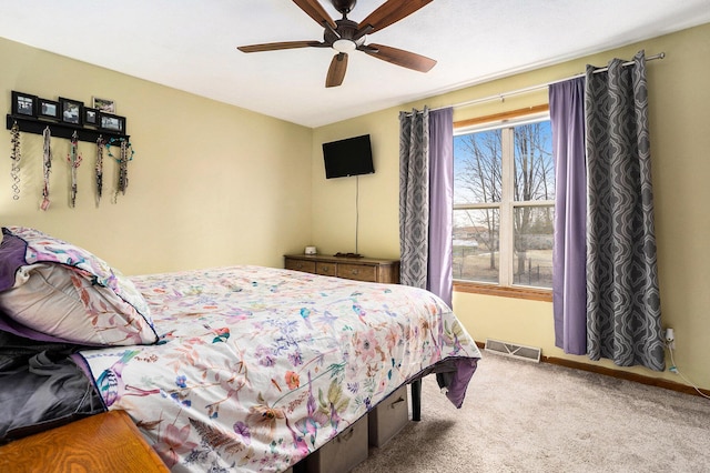 bedroom featuring ceiling fan, carpet flooring, visible vents, and baseboards