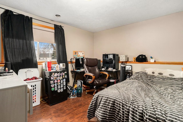 bedroom featuring a textured ceiling, wood finished floors, and visible vents