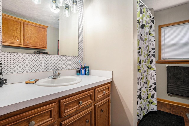 bathroom with a shower with shower curtain and vanity