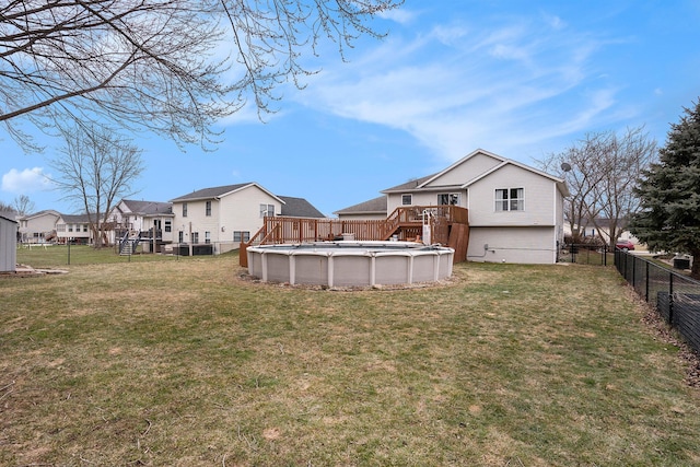 view of yard with a residential view, a fenced backyard, and a fenced in pool