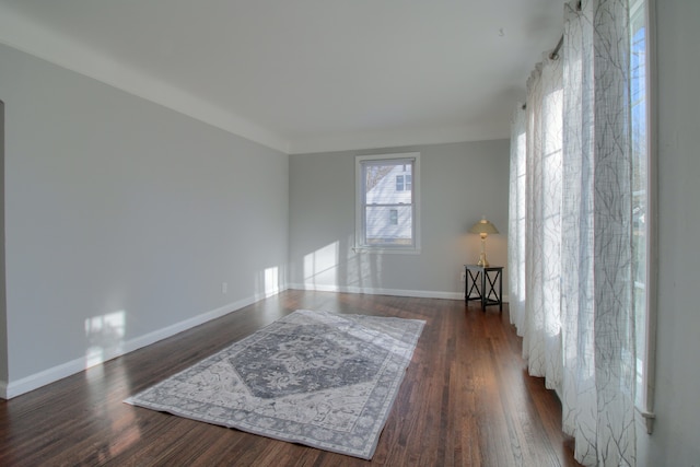 empty room featuring baseboards and wood finished floors