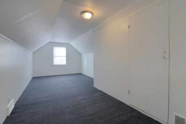 bonus room with carpet floors, visible vents, and vaulted ceiling