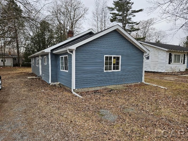 view of side of home featuring a chimney