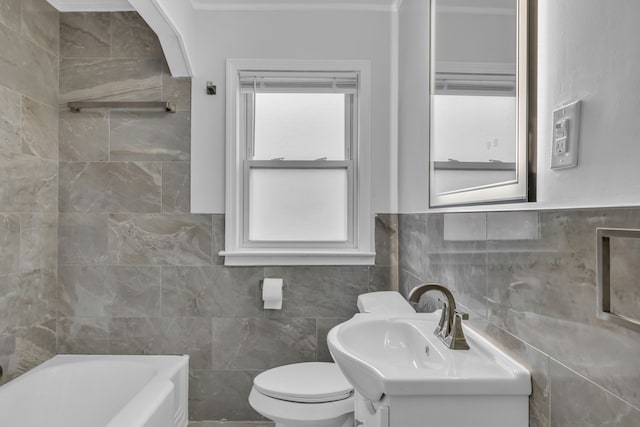 bathroom with toilet, vanity, a bath, and tile walls