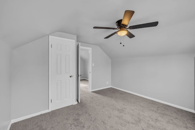 additional living space with lofted ceiling, ceiling fan, carpet flooring, and baseboards