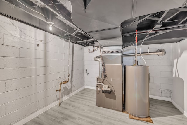 unfinished basement featuring water heater and wood finished floors