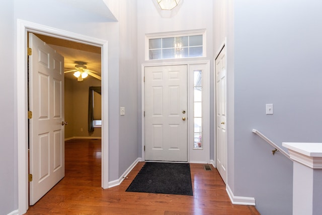 entrance foyer with visible vents, baseboards, and wood finished floors