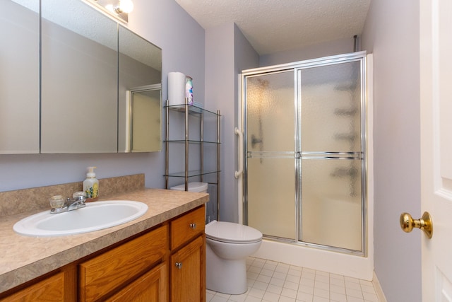 full bath featuring vanity, a stall shower, a textured ceiling, tile patterned floors, and toilet