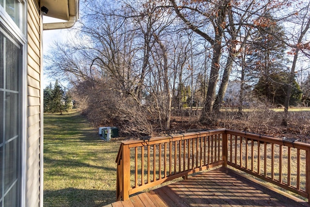 wooden terrace featuring a lawn