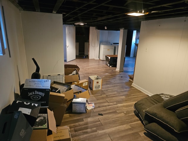 finished basement with washer / dryer and wood finished floors